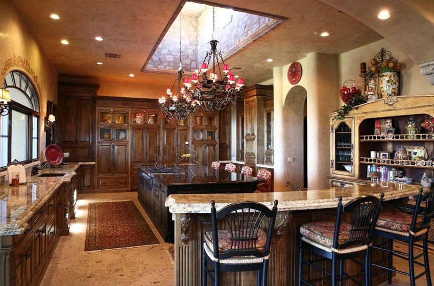Mediterranean kitchen with two types of granite counters and two islands
