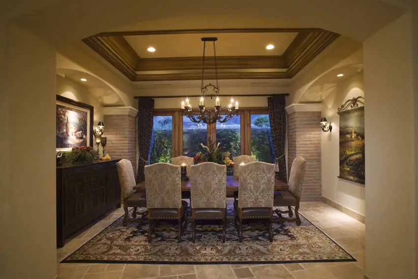 Dining room with deep tray ceiling and rustic chandelier