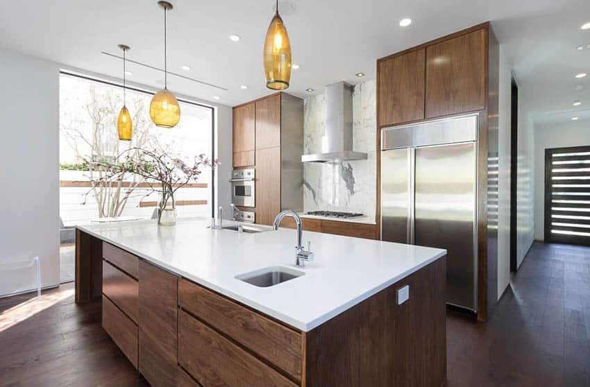 Modern kitchen with white quartz countertops and pendant lights
