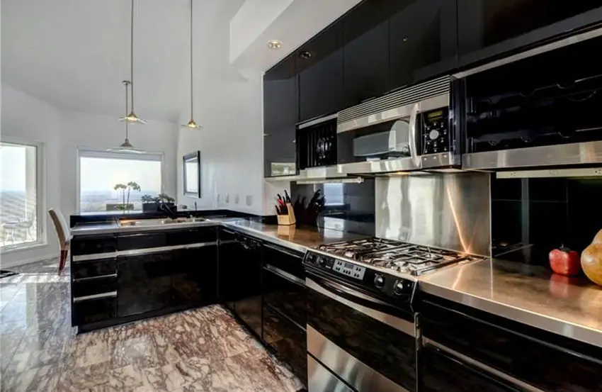 One wall black cabinet kitchen with pendant lights