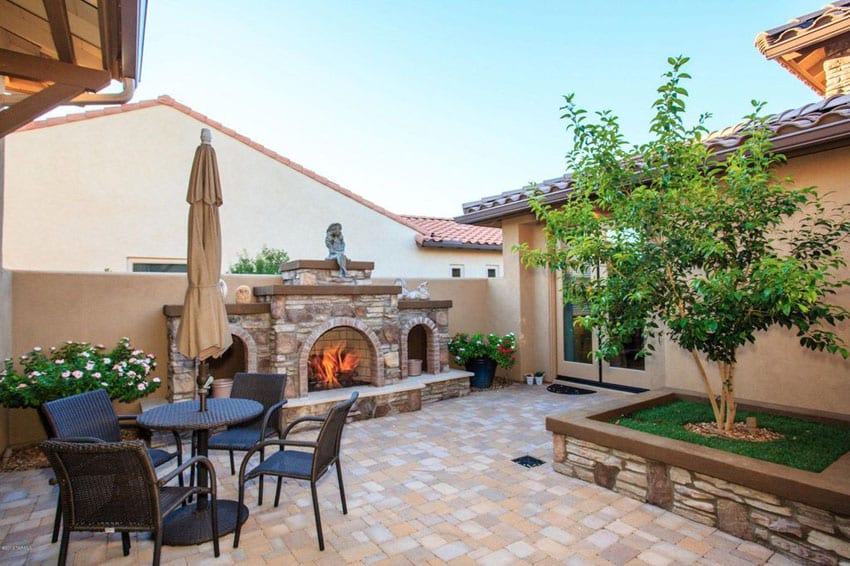 Paver stone patio with backyard fireplace