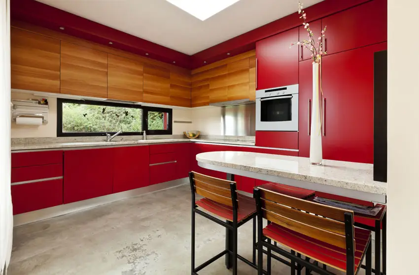 Red and wood grain cabinets, salt and pepper countertops and chairs
