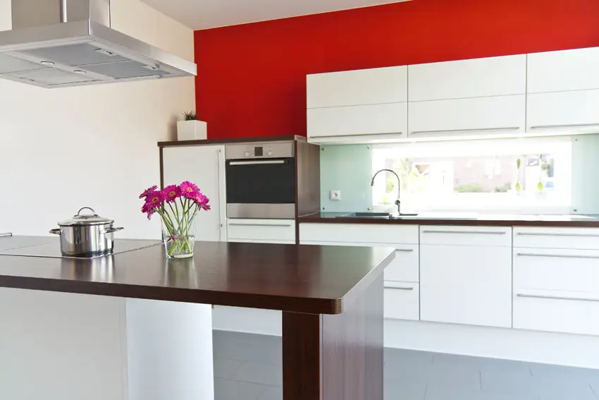 red-wall-kitchen-with-white-cabinets