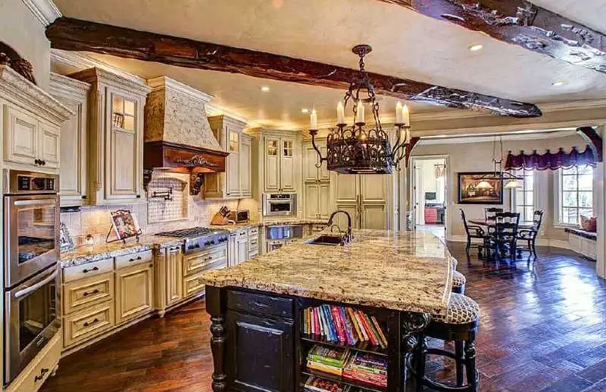 Kitchen with Gothic style chandelier cream colored cabinets and countertop with sink