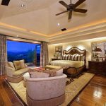 tan-luxury-master-bedroom-with-wood-floors-and-outdoor-balcony