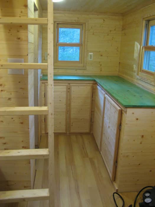Tiny house interior with ladder to loft bedroom