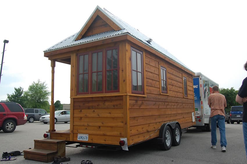 Tiny house on wheels being towed by truck