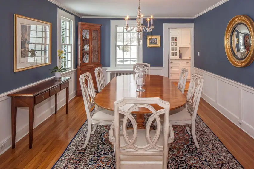 Traditional blue and white dining room with wainscoting and wood floors