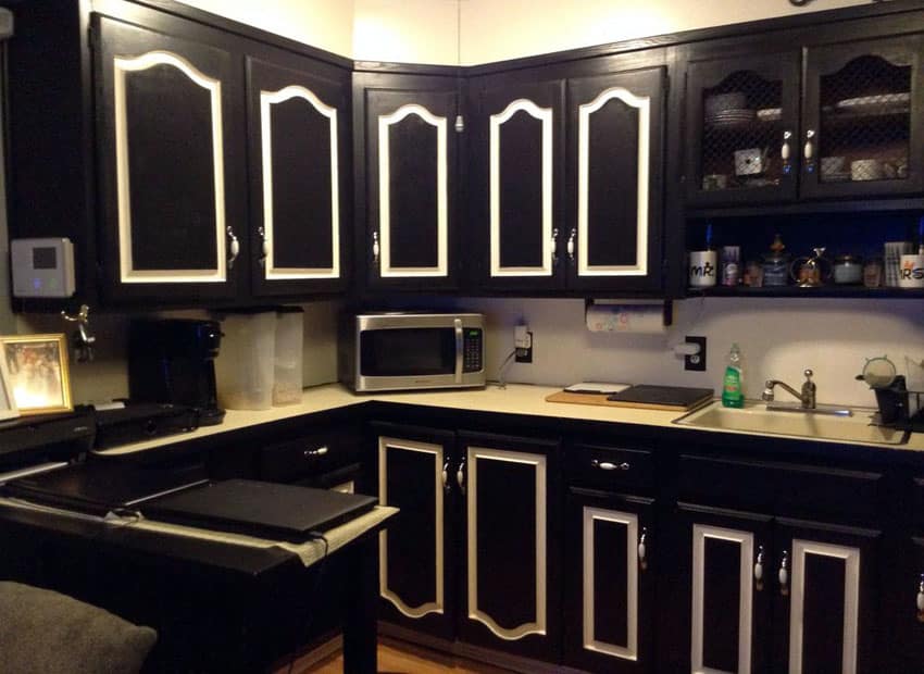 Traditional kitchen with l-shape black and white painted cabinets with white inlay doors