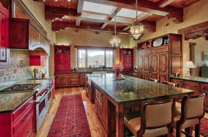 Traditional kitchen with red cabinets, light wood floors and large island with granite countertops
