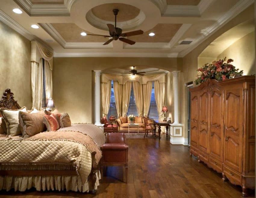 Traditional tan master bedroom with cupola ceiling and sitting area