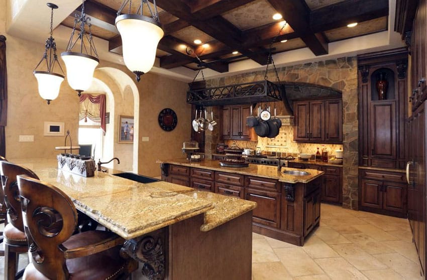 Italian kitchen with cabinets with dark stain and tan walls with stone accent wall 