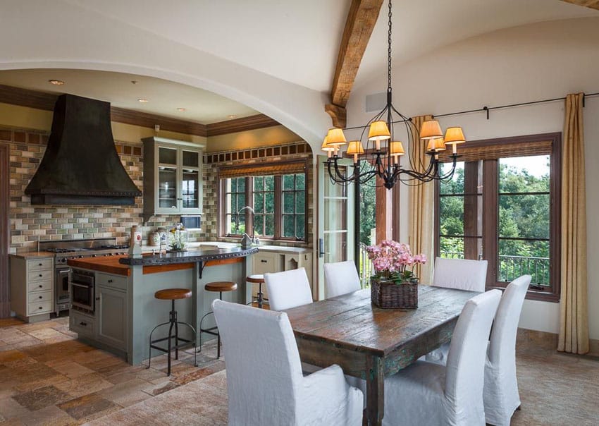 Tuscan style kitchen with breakfast bar island and small dining area