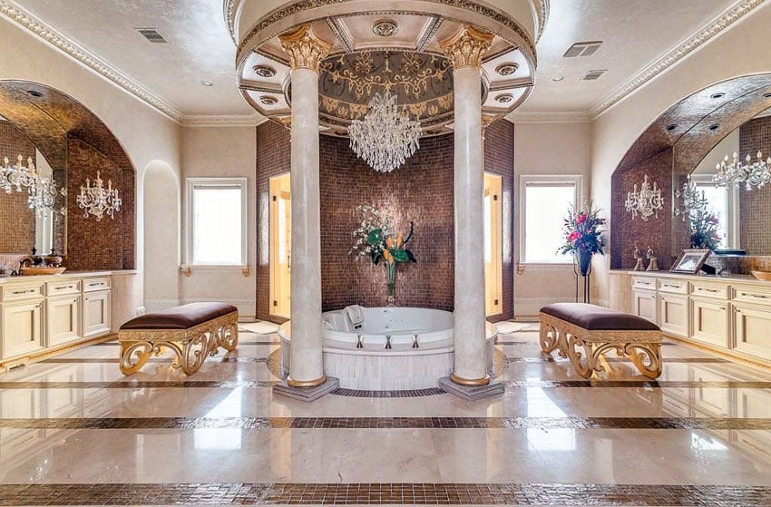 Amazing mansion bathroom with pillars, central tub, chandelier and mosaic tilework