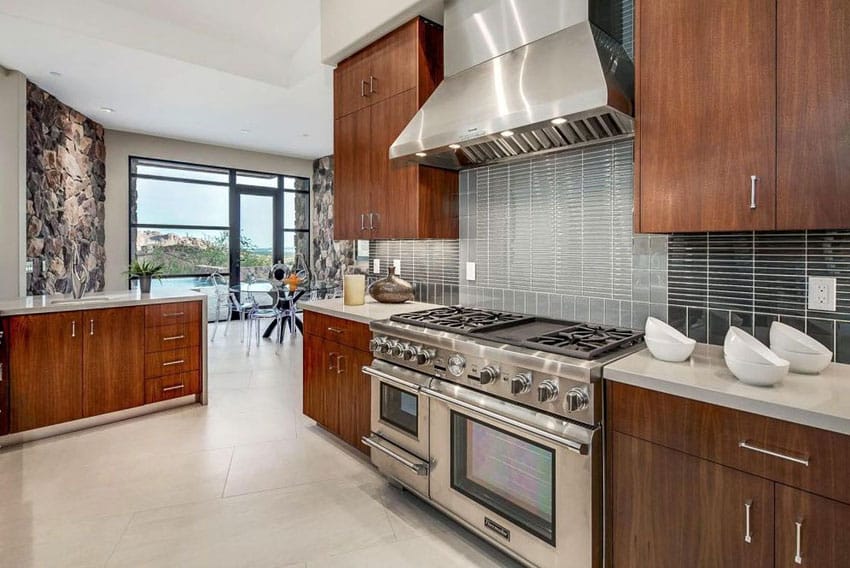 Brown cabinet kitchen with Corian countertops and two types of backsplash