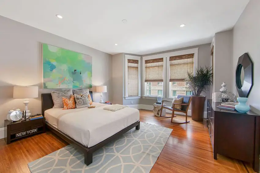 Contemporary master bedroom with tigerwood flooring