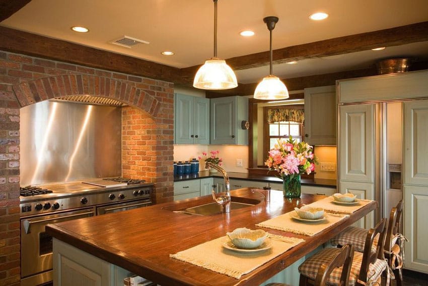 Country kitchen with butcher block counter island and green cabinets