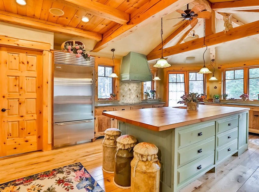Country kitchen with green cabinets and custom wood counter island