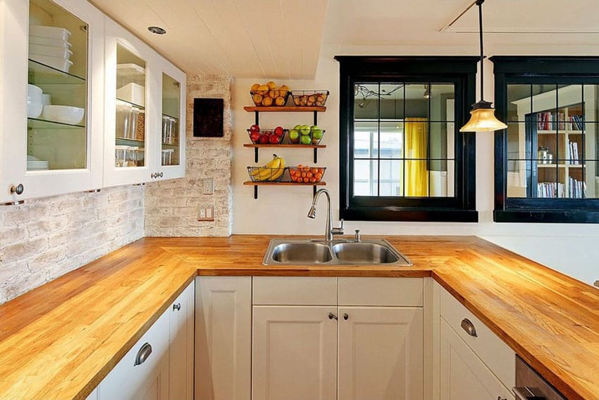 Country kitchen with maple wood countertops and white cabinets
