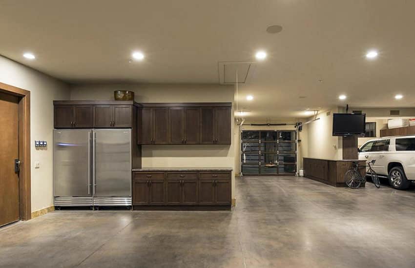 Garage with refrigerator and kitchen style cabinets