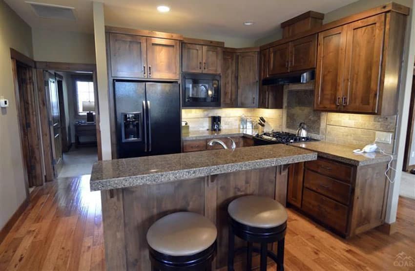 Kitchen with craftsman cabinets, small bar island and hickory floors