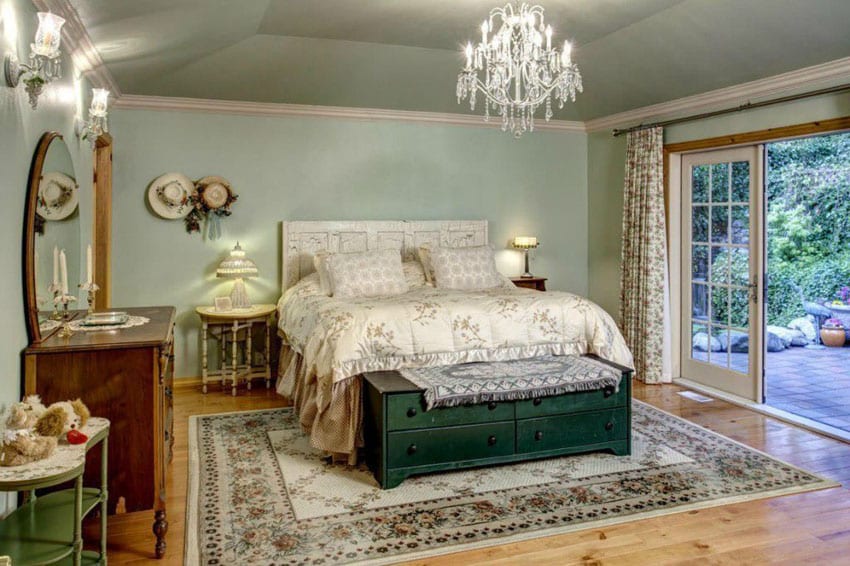 Luxury bedroom with knotty pine floors and chandelier