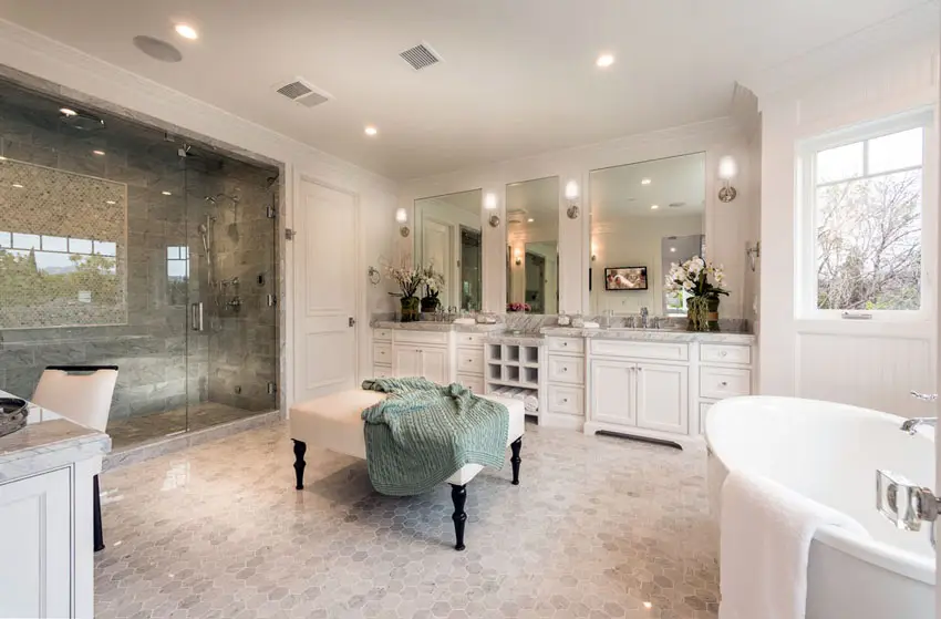Luxury master bathroom suite with white double sink vanity and large glass rainfall shower