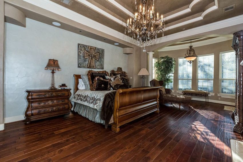 Luxury master bedroom with hickory hardwood floors, chandelier and elegant furniture
