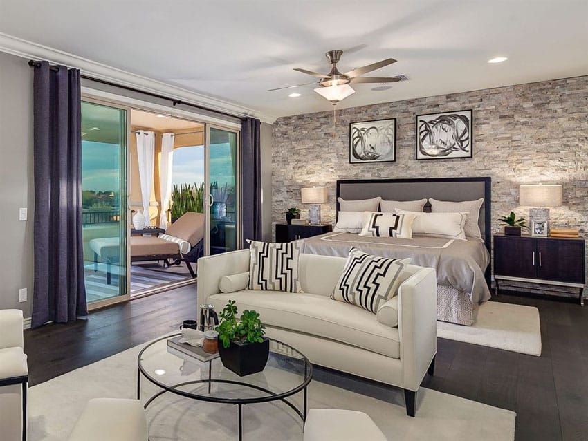 Master bedroom with hickory hardwood floors and stone accent wall