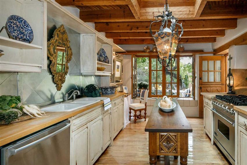 Mediterranean kitchen with wood countertops and rustic wood island