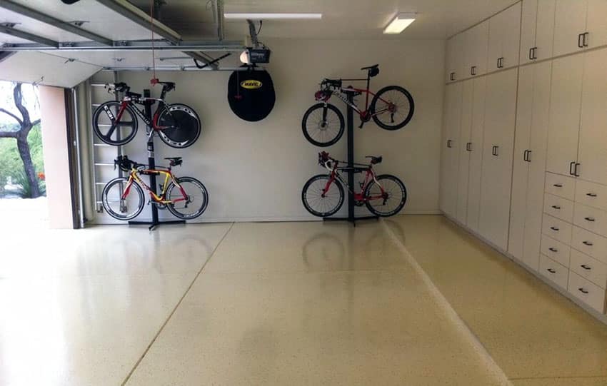 Organized garage with wall storage units bike racks and polyurea floor