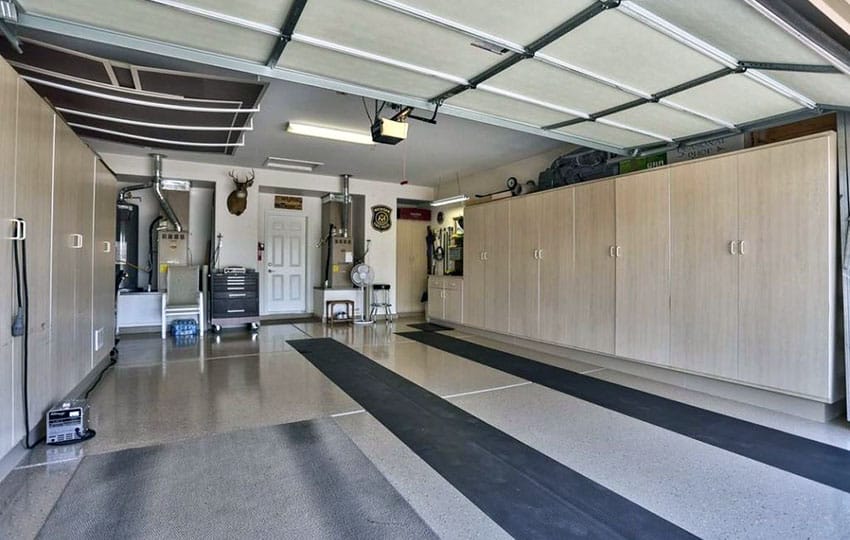 Remodeled garage with storage units and poly floors