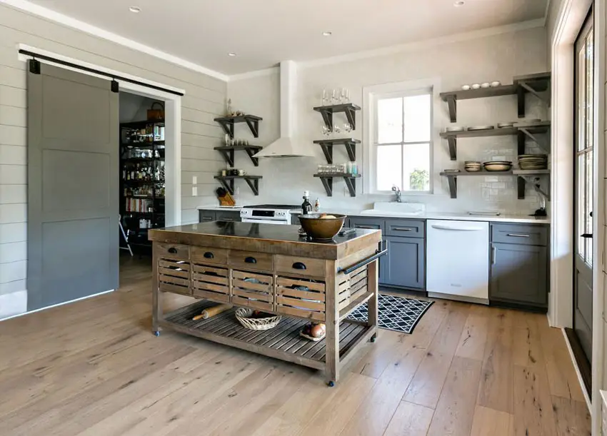 Kitchen with portable wood island and sliding barn door