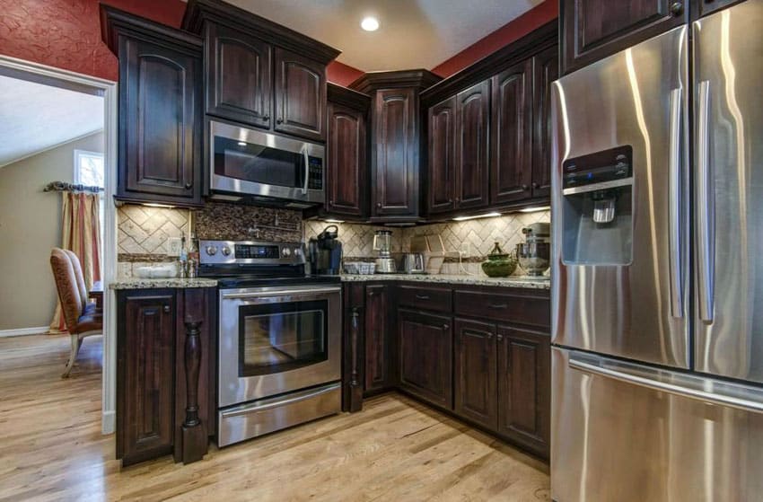 Small l shaped kitchen with custom cabinetry with dark wood finish