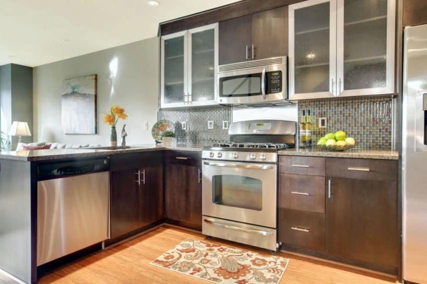 Kitchen with peninsula, wood plank floors and rug