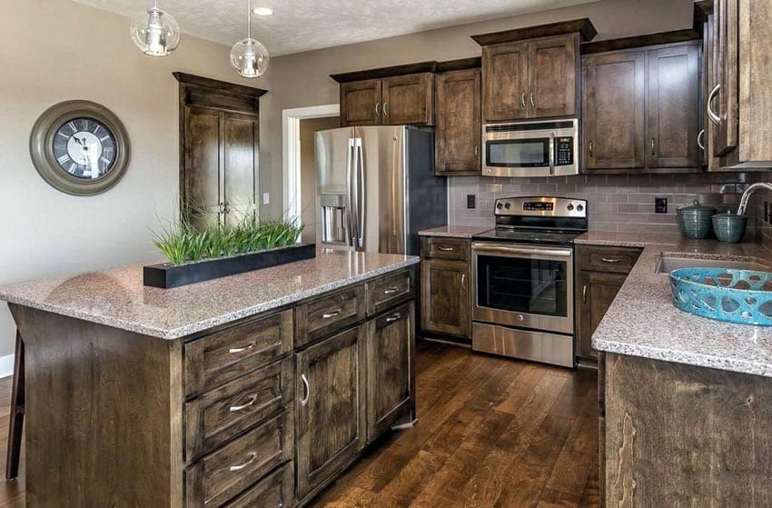 Traditional kitchen with dark craftsman style cabinetry and quartz countertops