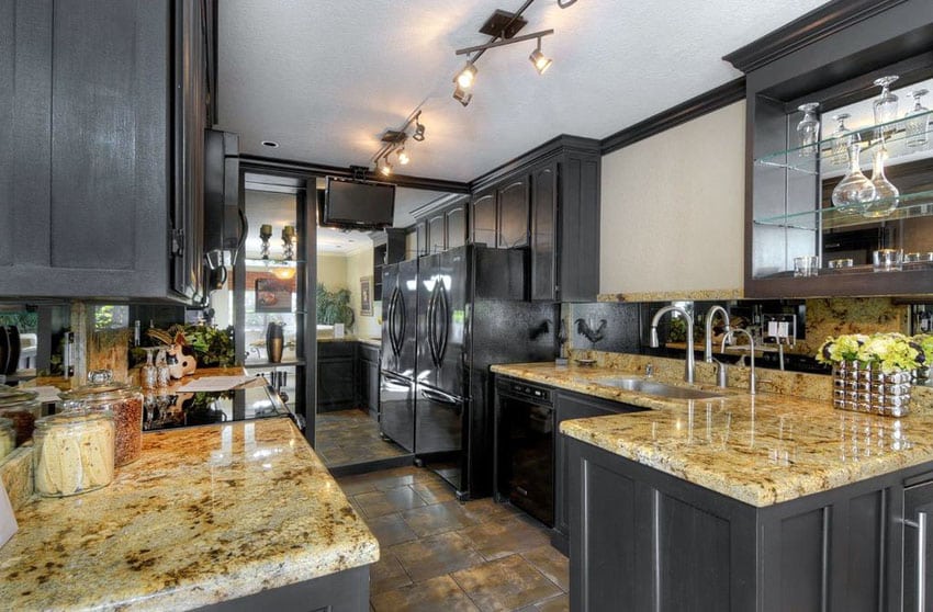 Transitional kitchen with dark cabinets cream granite counters and large mirror