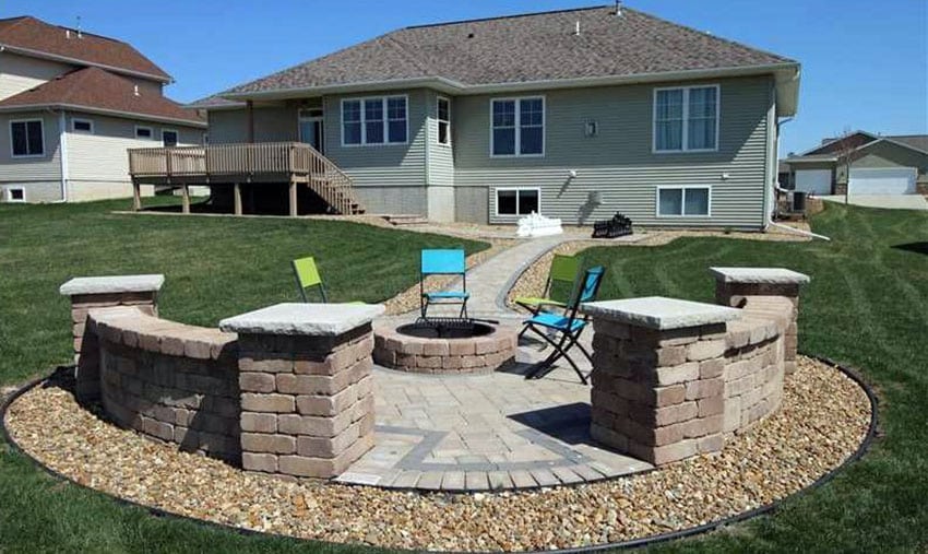 Backyard brick paver with outdoor pit surrounded by gravel border