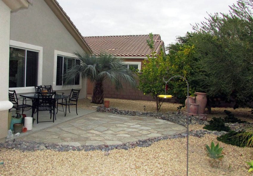 Backyard patio with irregular stones and gravel border