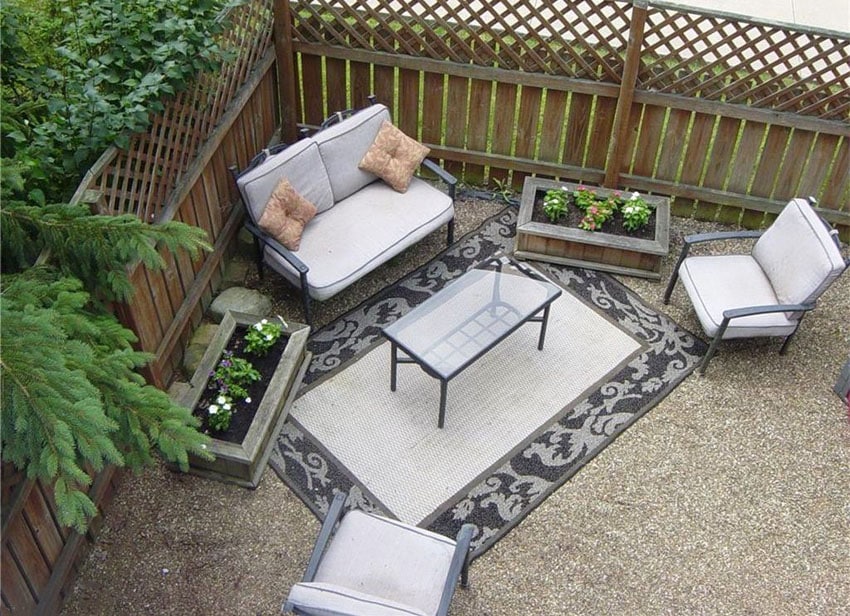 Backyard with pea gravel epoxy patio area rug and outdoor furniture