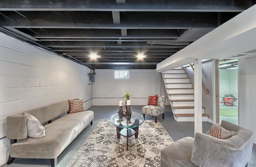 Basement living room with exposed beams and concrete floors