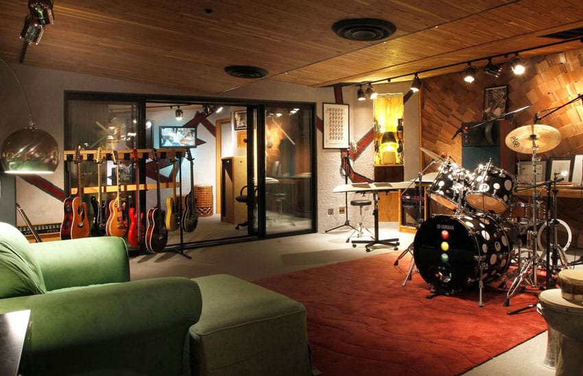 Basement music practice room with guitars keyboard and drum set