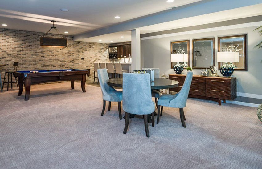 Basement with carpet, dining set, and dresser