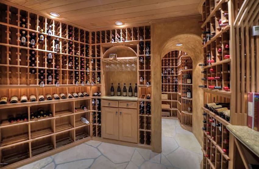 Wine racks with small granite countertop and stone floors