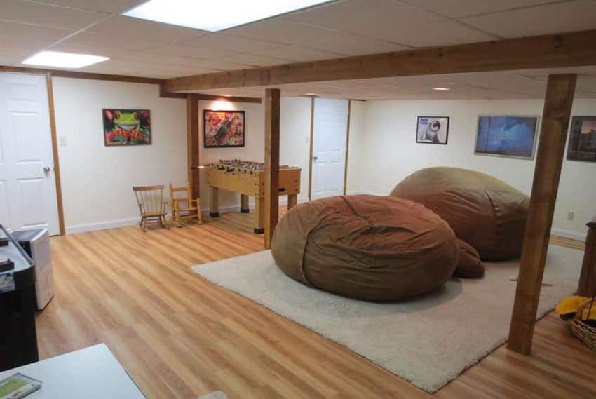 Basement with oversized bean bag seats and fooseball table