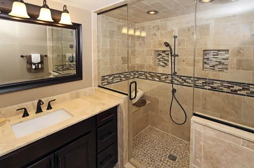 Bathroom with travertine tile glass tile design and pebble rock floor