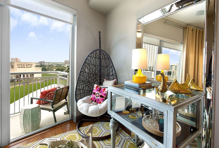 Bedroom with birds nest hanging wicker chair and outdoor views