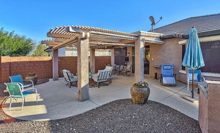 Concrete patio with pergola and gravel landscape