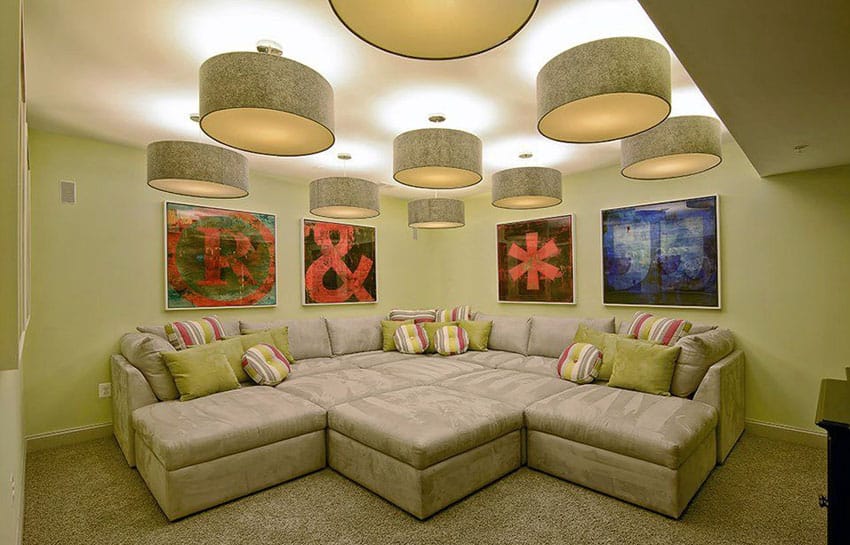 Contemporary basement with oversized modular sectional sofa seat and large drum pendant lights