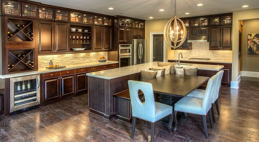 Dark tone kitchen with island, dining table and bench combo